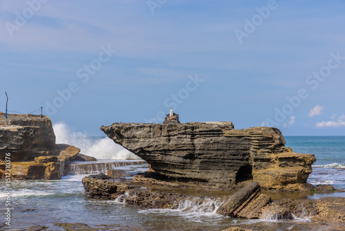 Tanah Lot Temple on the island of Bali known as the island of Gods. Sitting on top of rock island over looking turquoise blue beaches in Bali Indonesia