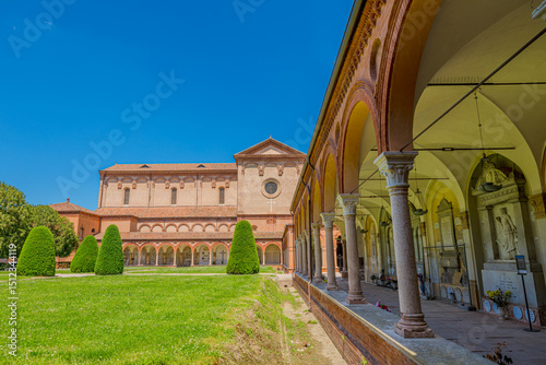  Ferrara, Italy - May 17, 2025: Wide angle view of San Cristoforo church in Charterhouse of Ferrara cloister with columns framing the main building. Summer day in Ferrara, Italy photo