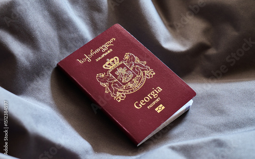 Georgia passport resting on gray fabric background