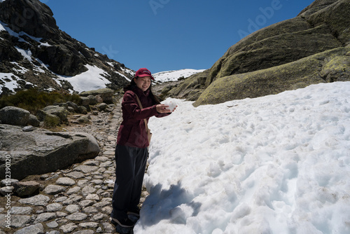 Asian woman enjoying snowy Sierra de Gredos scenery