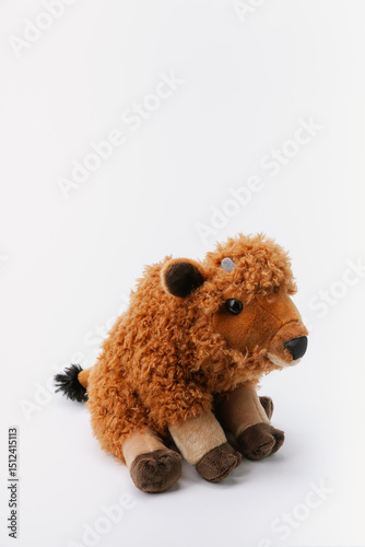 Bison stuffed animal sitting on a white background