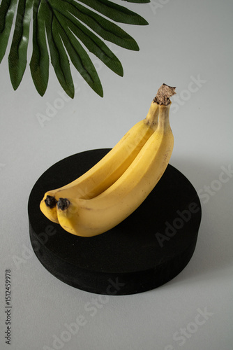 Organic bananas on a black shelf ready to be eaten