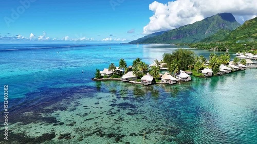 Drone Tahiti. Aerial view of Moorea island lagoon, overwater bungalows in clear ocean water. Luxury honeymoon vacation, romantic getaway. French Polynesia.