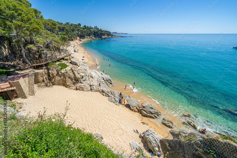 Fototapeta premium Tourists enjoying summer at scenic beach in costa brava, calonge, spain