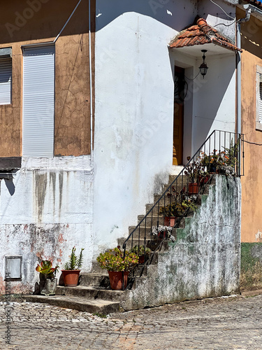 Exterior staircase of rustic Mediterranean house with potted plants