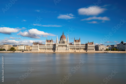 Stunning Front View of the Hungarian Parliament Building Against the Clear Daylight Sky, Overlooking the Danube River in Budapest