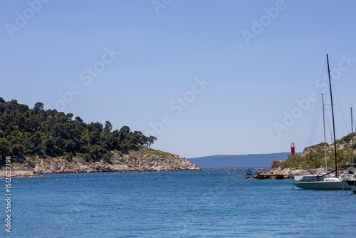 Fototapeta Naklejka Na Ścianę i Meble -  Amazing seascape of Adriatic sea. Near Makarska beach Croatia, Europe. Colorful summer view of small beach. Croatian coast with clear water and pine trees around.