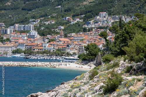 Fototapeta Naklejka Na Ścianę i Meble -  Amazing seascape of Adriatic sea. Near Makarska beach Croatia, Europe. Colorful summer view of small beach. Croatian coast with clear water and pine trees around.