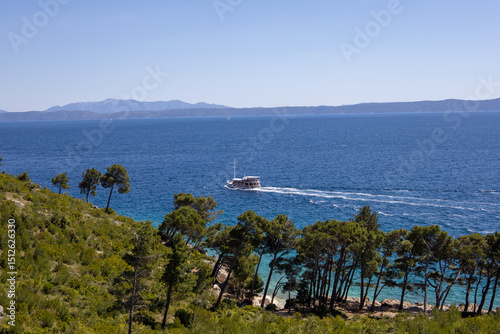 Fototapeta Naklejka Na Ścianę i Meble -  Amazing seascape of Adriatic sea. Near Makarska beach Croatia, Europe. Colorful summer view of small beach. Croatian coast with clear water and pine trees around.