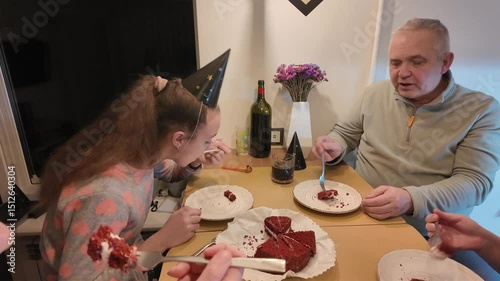 Three generations of a happy family — grandmother, grandfather, mother, and daughter — celebrating the little girl’s birthday together at home, enjoying a warm and joyful moment.
