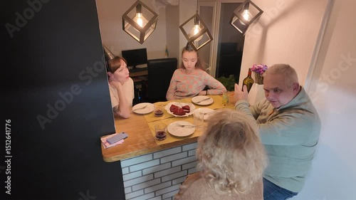Three generations of a happy family — grandmother, grandfather, mother, and daughter — celebrating the little girl’s birthday together at home, enjoying a warm and joyful moment.