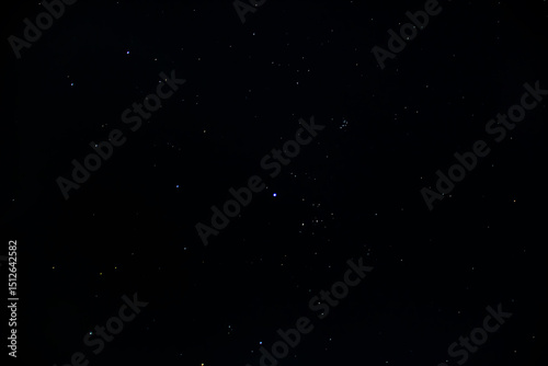 Fototapeta Naklejka Na Ścianę i Meble -  The clear black night sky is strewn with bright glowing stars and constellations	
