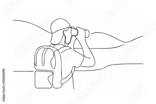 Hiker with backpack using binoculars on mountaintop