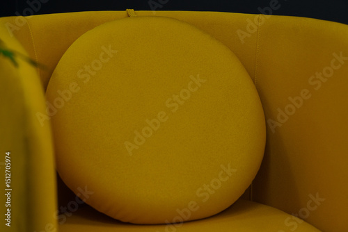 Vibrant Yellow Accent Chair with Rounded Pillow: Modern Interior Design, Cozy Living Room Decor, Warm Toned Comfort, Plush Fabric Texture, Home Furnishings