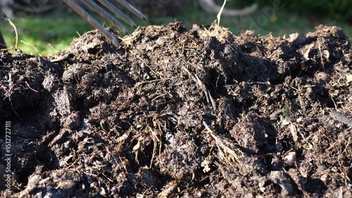farmer collecting soil samples in a test tube in a field. Agronomist checking soil carbon and plant health on a farm