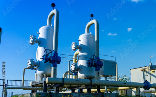 Φωτογραφία Two large gas processing units with valves and piping stand prominently against