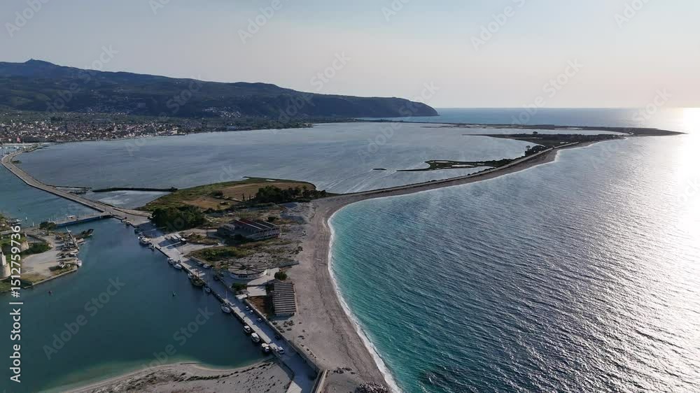 A receding aerial view of Ammoglossa beach, beach head entrance to the Marina, Lefkada, Greece. A receding aerial view of Ammoglossa beach, beach head entrance to the Marina, Lefkada, Greece.