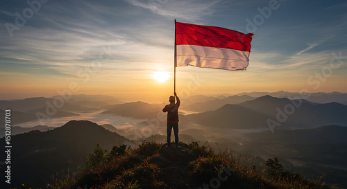 Person Raising Indonesian Flag at Sunrise on Mountaintop