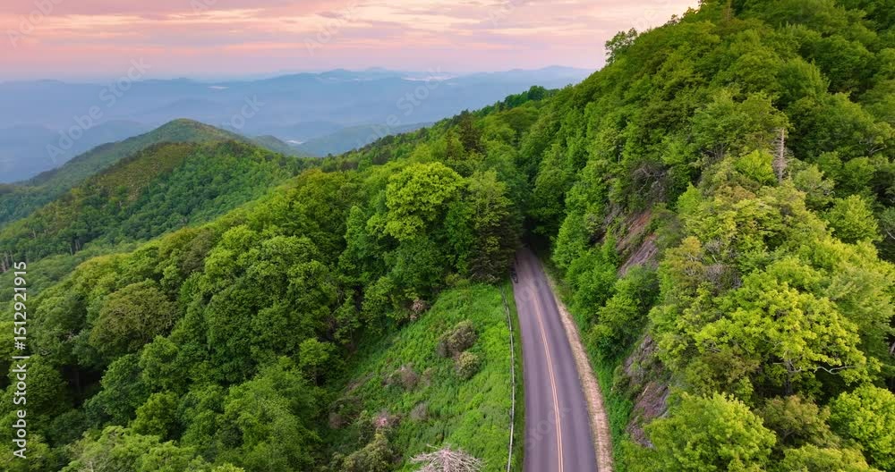 Blue Ridge Parkway road in summer woods of Appalachian mountains at sunset. Road trip driving in wild nature in summertime season