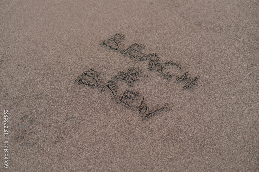 Fototapeta premium Beach and Brew – Handwritten Message on Volcanic Sand