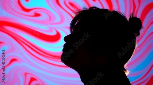A silhouette of a person with a bun hairstyle, facing forward against a background of swirling pink and blue abstract shapes