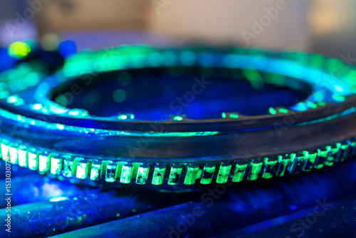 A high-precision aerospace component is undergoing fluorescent penetrant testing with distinctive green indications. Non-destructive evaluation exposes  discontinuities in this critical flight safety 