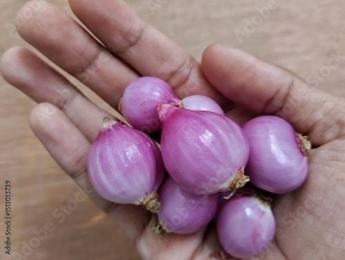 red onion on wooden background. Red onion is very beneficial for health, such as maintaining the heart, lowering blood sugar, and preventing cancer.