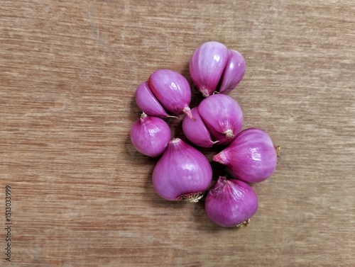 red onion on wooden background. Red onion is very beneficial for health, such as maintaining the heart, lowering blood sugar, and preventing cancer.