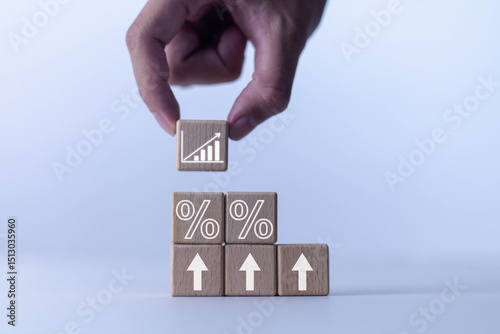 
Concept of rising wooden blocks with percentage symbol, up direction icon, high inflation concept, financial interest rates and mortgage rates, rising selling prices and taxes. 