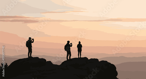 Silhouettes of three photographers capturing sunset on mountain peak  