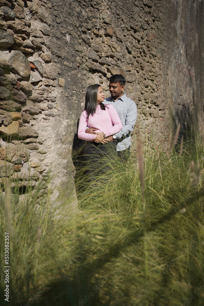 Fototapeta premium A joyful young couple sharing a loving moment on a peaceful street surrounded by greenery