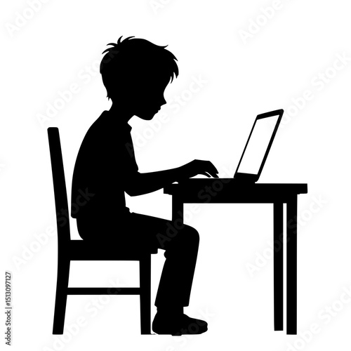 Young boy typing on laptop while sitting at a desk  