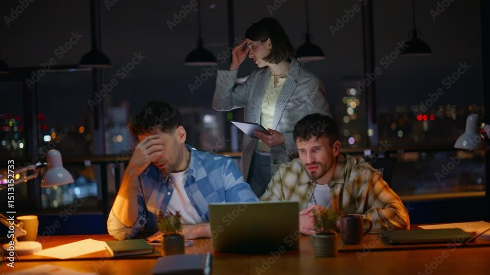 Annoyed startupers looking computer screen worried problem at overtime office