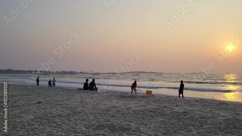 A group of Indian young people playing cricket of the Malpe beach, Udupi.