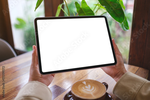 Mockup image of a woman holding digital tablet with blank white desktop screen