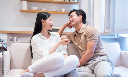 Couple shares intimate moment on couch in brightly lit living space fostering connection and conversation