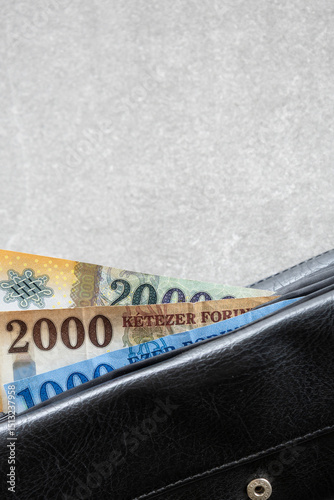 black wallet with partially visible hungarian forint banknotes