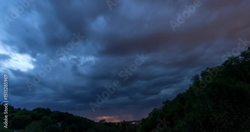 Timelapse of Dramatic Clouds Moving Across the Sky at Dusk in Hilly Landscape