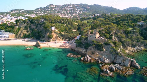 Castell d'en plaja dominating lloret de mar beach and turquoise mediterranean sea