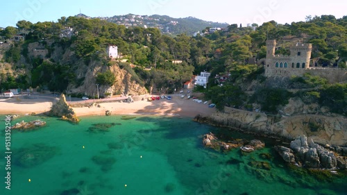Castell d'en plaja dominating lloret de mar beach and turquoise mediterranean sea photo