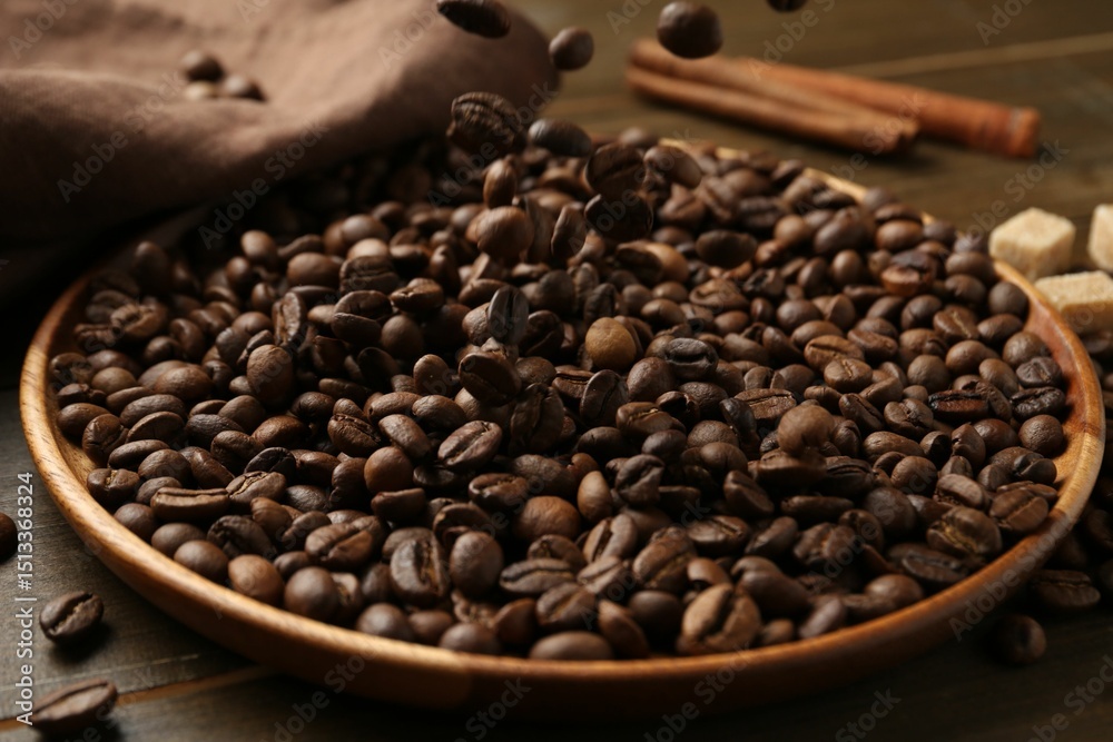 Fototapeta premium Pouring coffee beans onto plate at table, closeup