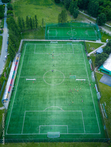 View from above of the all-season football pitch with players.