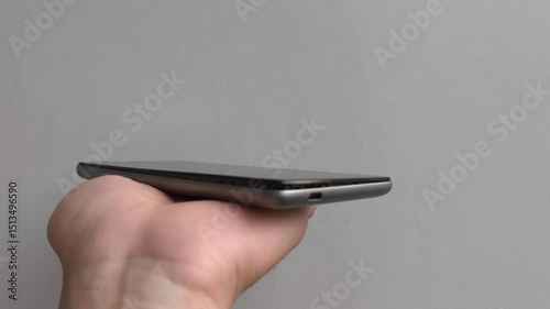 A hand shows badly damaged smartphone with open screen