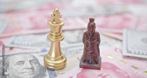 US-China trade relations, geopolitical tensions, tariff war resolution : A king chess piece paired with a Chinese emperor warrior figure rests on a backdrop of US dollar and Chinese yuan banknotes.