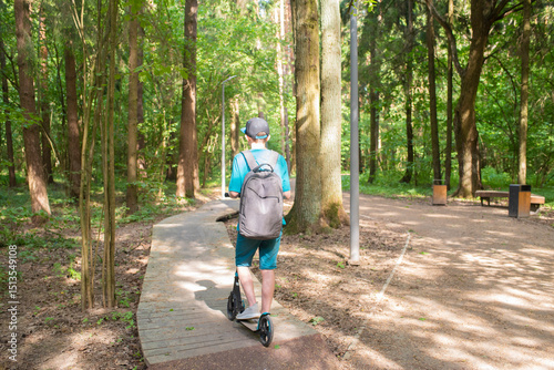 Wallpaper Mural A 12 year old boy in a cap and shorts rides a scooter on a pump track in Borovsky Park in Moscow in the spring.	 Torontodigital.ca