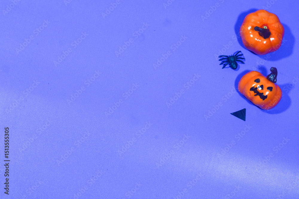 Fototapeta premium Vibrant Halloween decoration with orange and purple background. Perfect for party designs, invitations, or themed content.