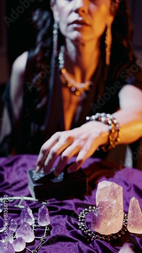 Fortune teller arranging amethyst crystals and tarot cards