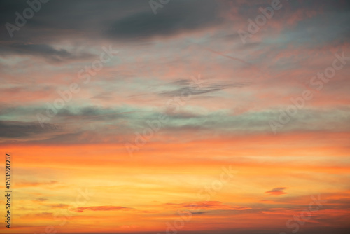 Sky,Beautiful sunset view, luxury soft gradient orange gold clouds and sunlight on the blue dramatic sky perfect for the background, morning, evening,Twilight, climate change,horizontal sunset photo