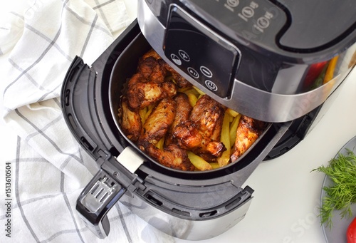 Cooking potatoes with chicken in a deep fryer. Fast and convenient.
