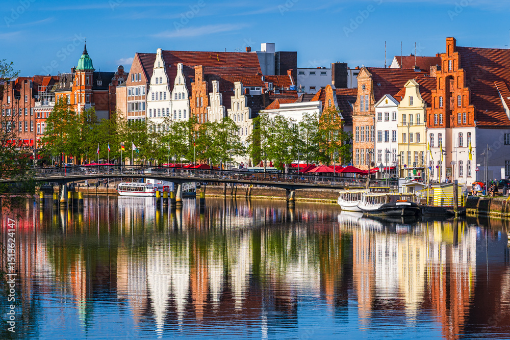 Obraz premium Historic skyline along the Trave river in the old town of Lubeck, Germany on a summer day